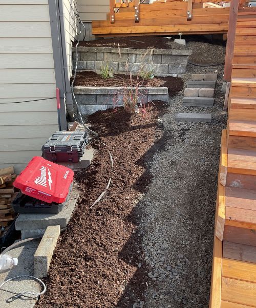 A red suitcase sitting on top of a pile of dirt